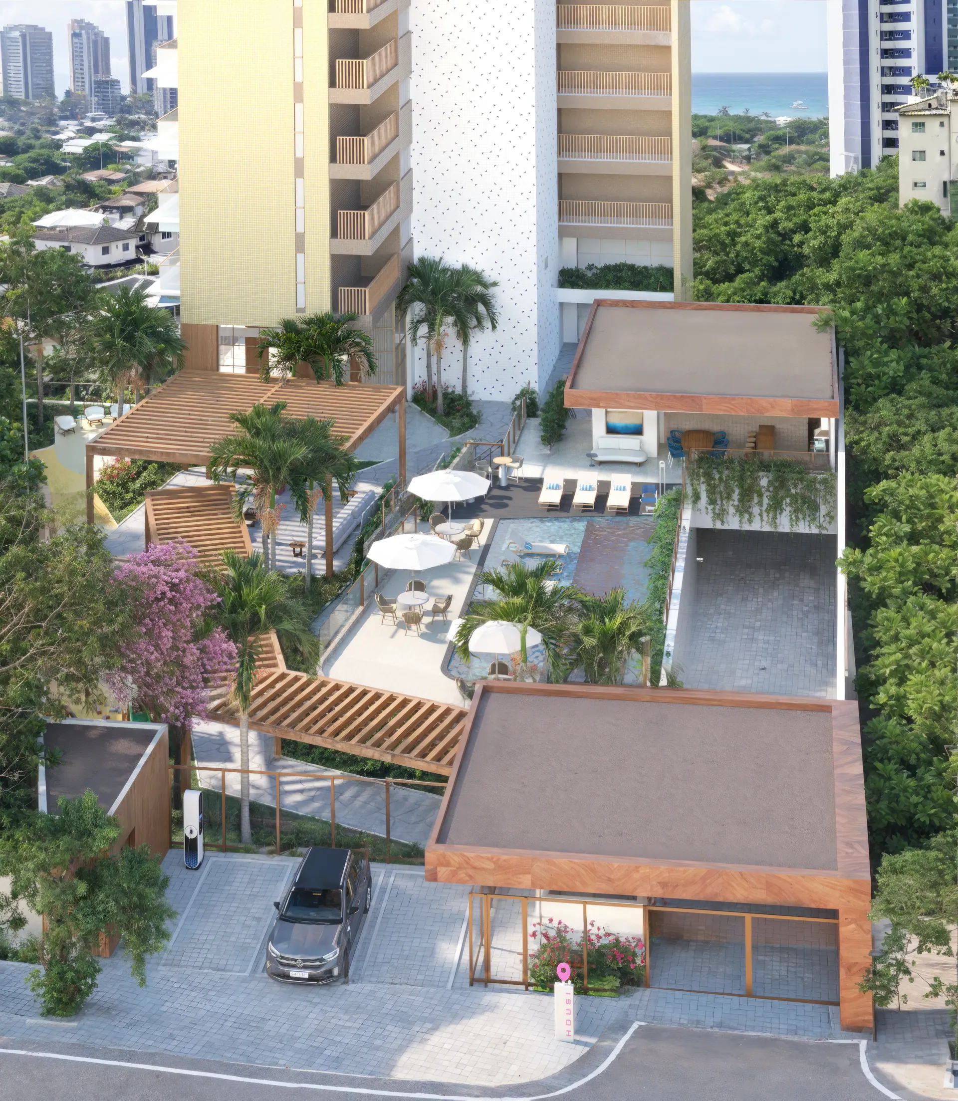 Vista aérea do embasamento de lazer: piscina, pergolados, decks e a portaria